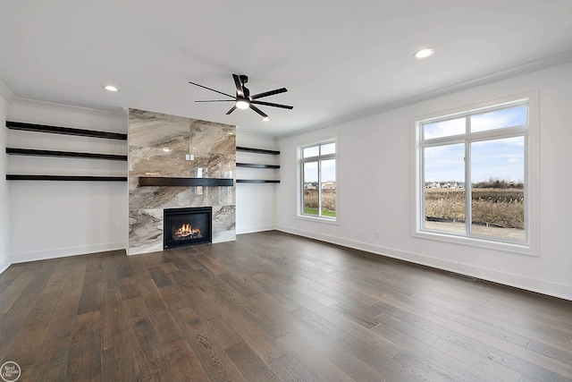 unfurnished living room with baseboards, visible vents, a tile fireplace, dark wood-style floors, and recessed lighting