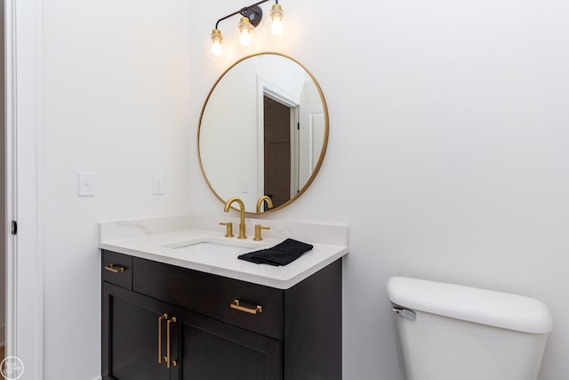 half bathroom featuring toilet and vanity