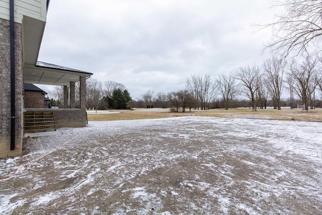 view of yard layered in snow