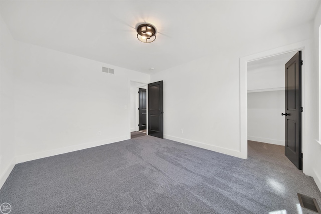 unfurnished bedroom with a spacious closet and a closet