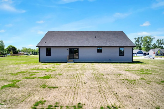 back of property featuring a lawn