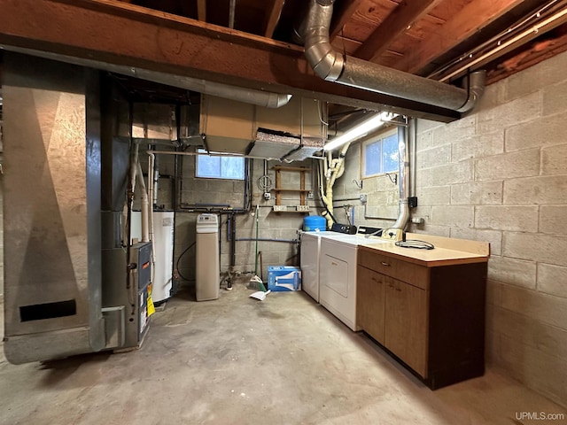 basement with gas water heater and washing machine and dryer