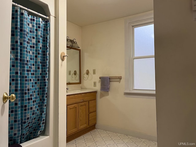 bathroom with shower / bathtub combination with curtain, tile floors, and vanity