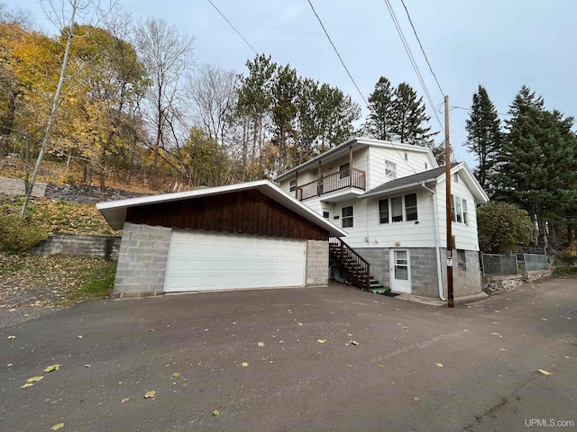 view of front of home featuring a balcony and a garage