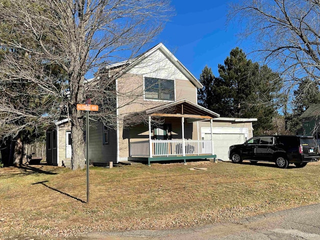 view of property with a front yard, a garage, and covered porch