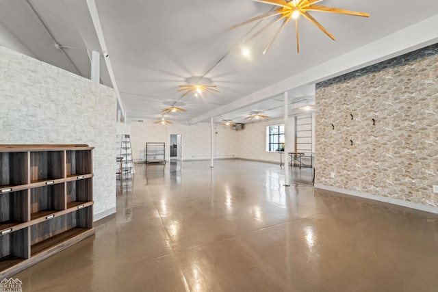 unfurnished living room with concrete flooring and ceiling fan