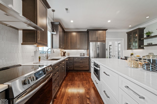 kitchen with pendant lighting, sink, white cabinetry, stainless steel appliances, and french doors