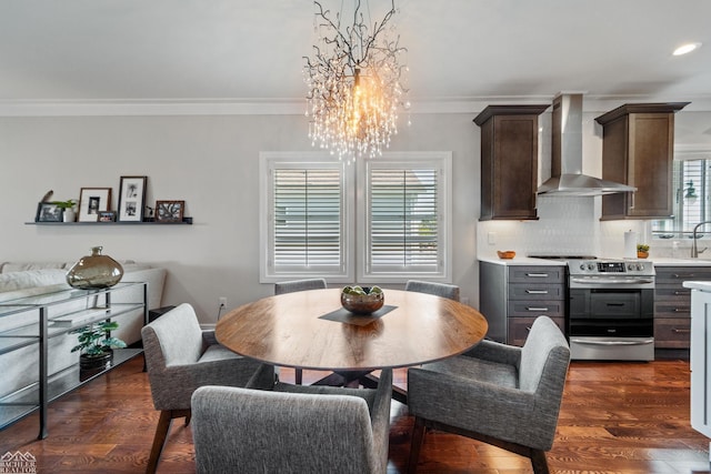 dining area with crown molding and dark hardwood / wood-style floors