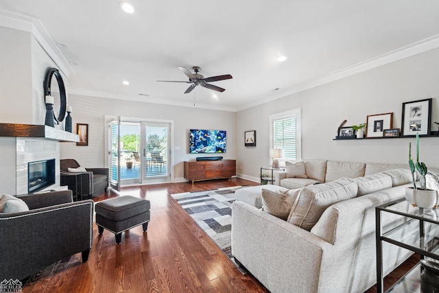 living room featuring crown molding, ceiling fan, and dark hardwood / wood-style floors