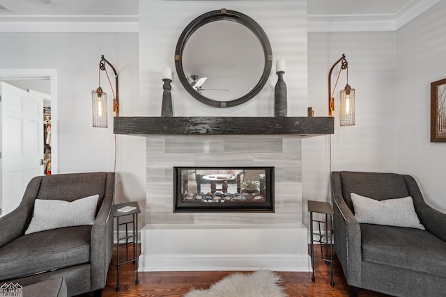 sitting room featuring dark wood-type flooring and a fireplace