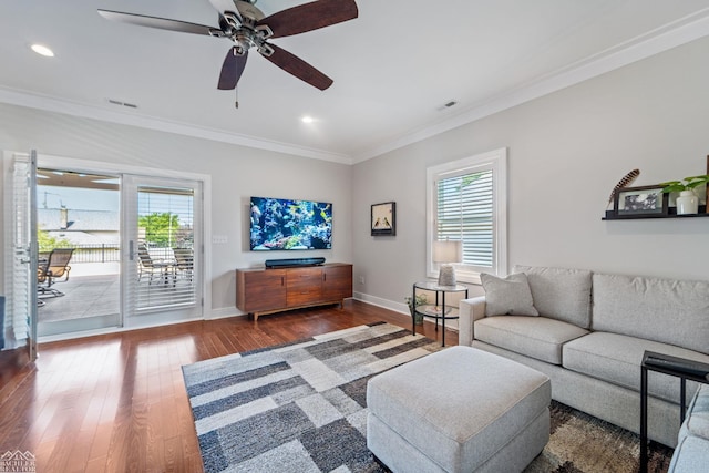 living room with hardwood / wood-style flooring, ornamental molding, and ceiling fan