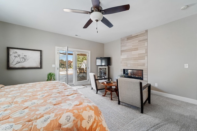 bedroom with ceiling fan, access to outside, light colored carpet, and a fireplace