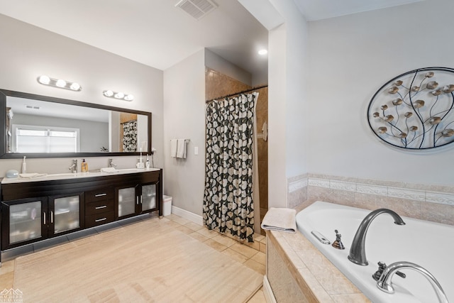 bathroom featuring shower with separate bathtub, tile patterned floors, and vanity