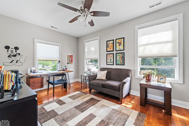 living area featuring hardwood / wood-style flooring and ceiling fan