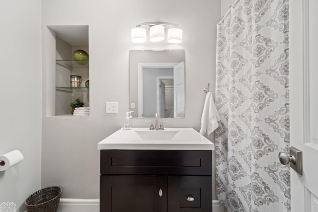 bathroom featuring vanity and curtained shower