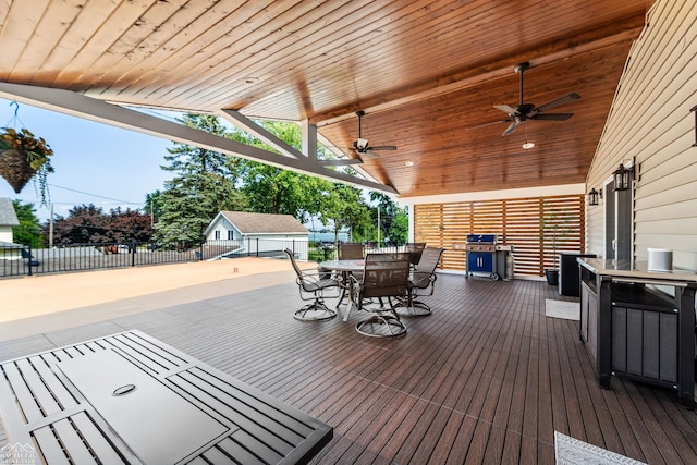 deck with a grill and ceiling fan