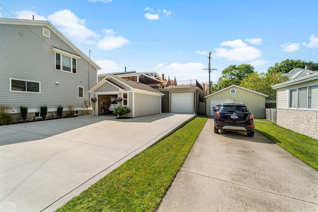 view of front of house with an outbuilding, a garage, and a front lawn