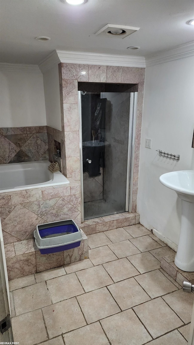 bathroom with tile patterned flooring, independent shower and bath, and ornamental molding