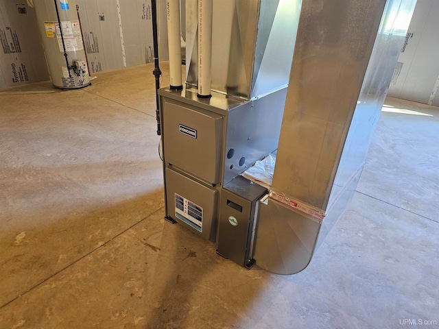 utility room featuring heating unit and gas water heater