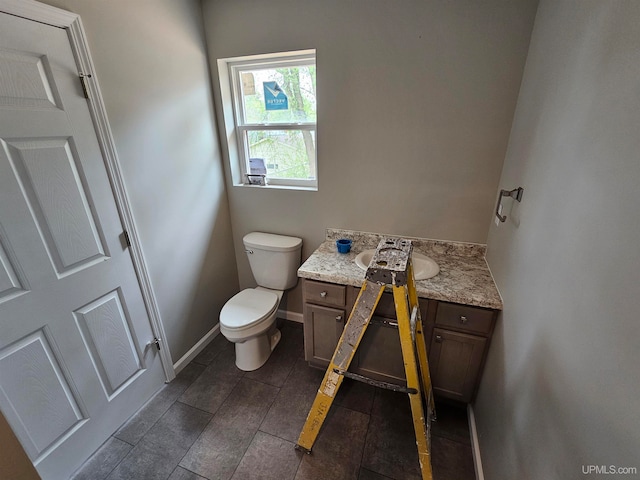 bathroom featuring toilet and vanity