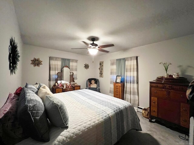 bedroom with ceiling fan, light colored carpet, and baseboard heating