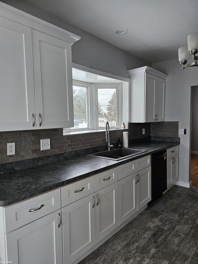 kitchen with sink, black dishwasher, decorative backsplash, and dark hardwood / wood-style floors