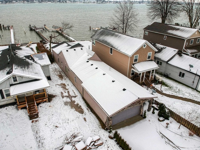 snowy aerial view with a water view