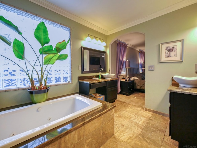 bathroom with vanity, crown molding, and tiled bath