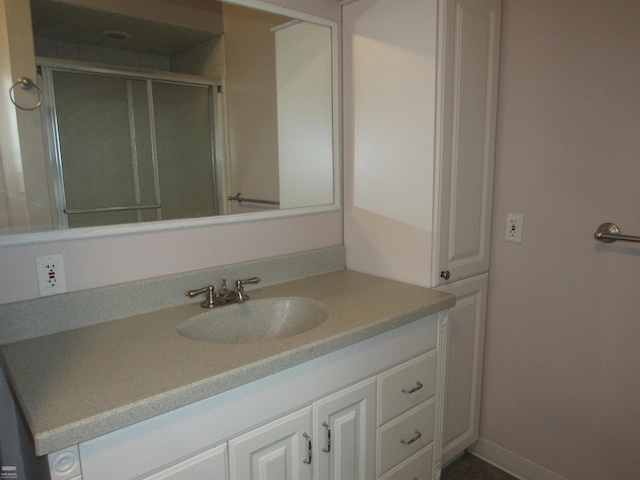 bathroom featuring vanity and a shower with shower door