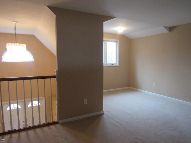 additional living space with vaulted ceiling and carpet flooring