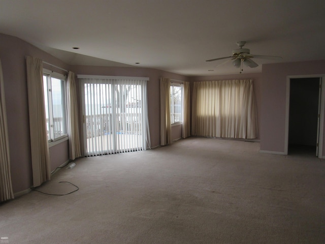 spare room featuring light colored carpet and ceiling fan