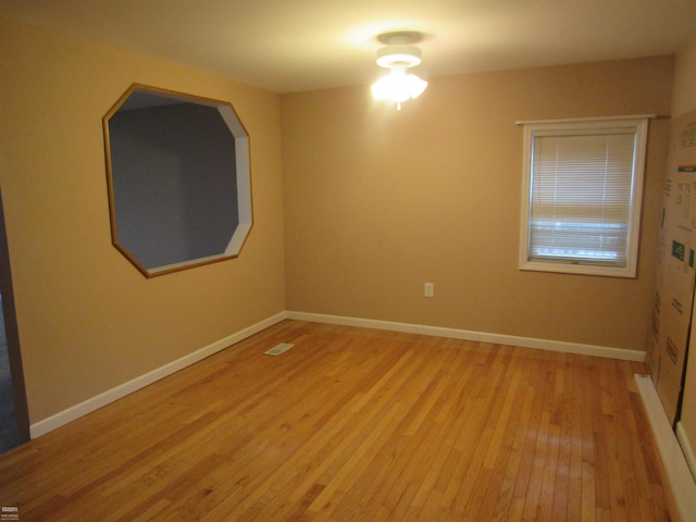 unfurnished room with light hardwood / wood-style floors