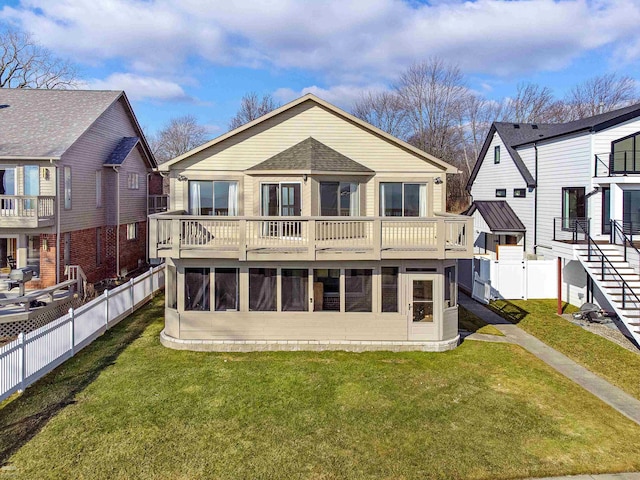 back of property with a balcony and a lawn