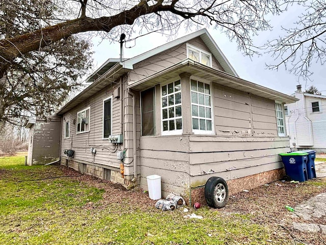 view of side of home featuring a yard