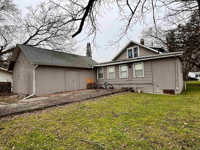 back of property featuring a lawn