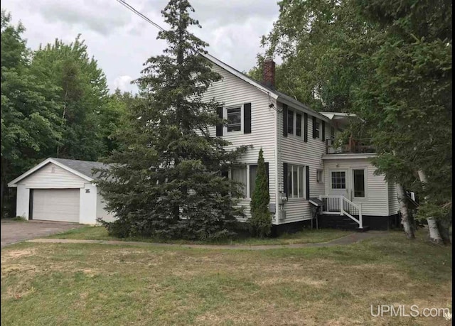 colonial home featuring a front yard and a garage