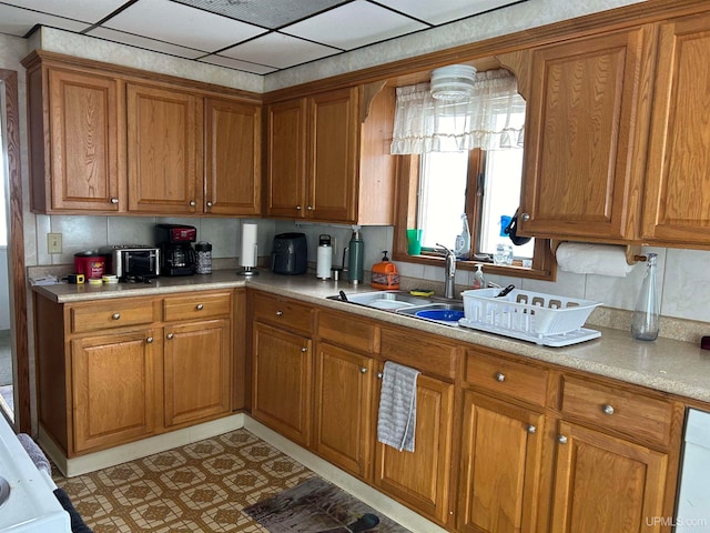 kitchen with light tile floors, tasteful backsplash, and sink