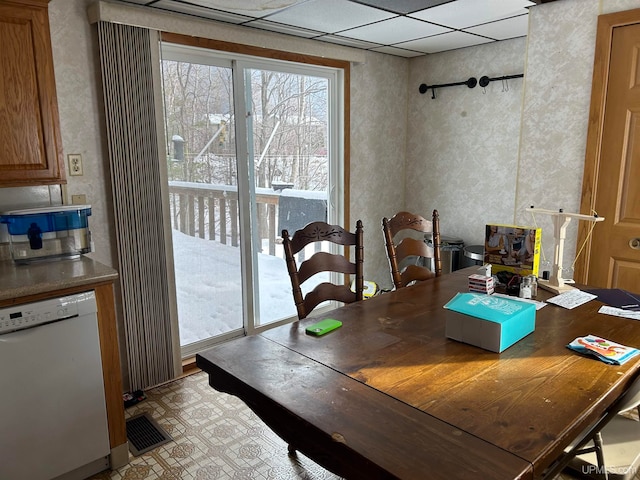 dining area featuring a paneled ceiling