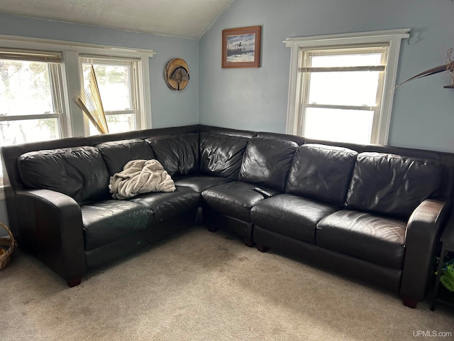 carpeted living room featuring vaulted ceiling