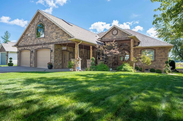 view of front of property with covered porch, a garage, and a front lawn