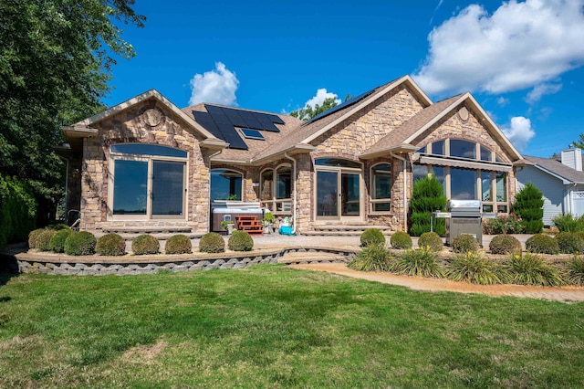 craftsman-style house with solar panels and a front lawn