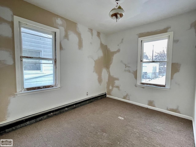 carpeted spare room featuring baseboard heating