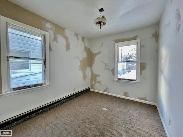 empty room with carpet and a baseboard heating unit