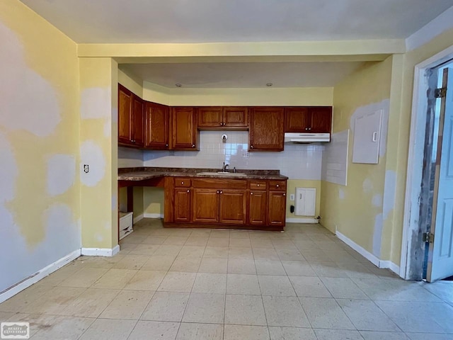 kitchen featuring decorative backsplash and sink