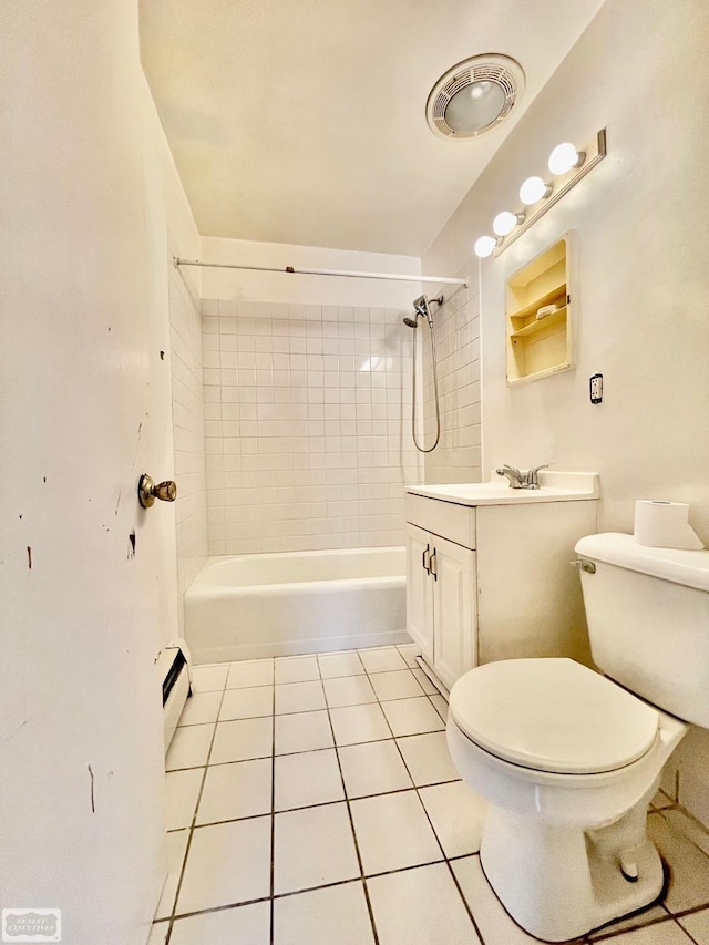 full bathroom with tiled shower / bath combo, tile patterned flooring, a baseboard heating unit, vanity, and toilet