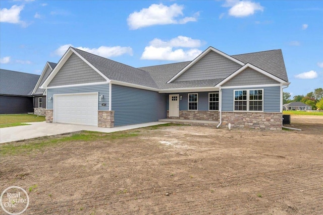 3 Riley Rd, Saint Clair, MI 48079 - craftsman house with stone siding, a garage, concrete driveway, and a porch