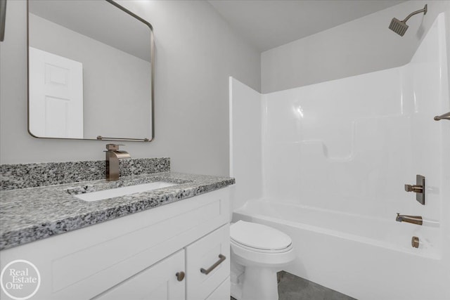 full bathroom featuring washtub / shower combination, vanity, and toilet