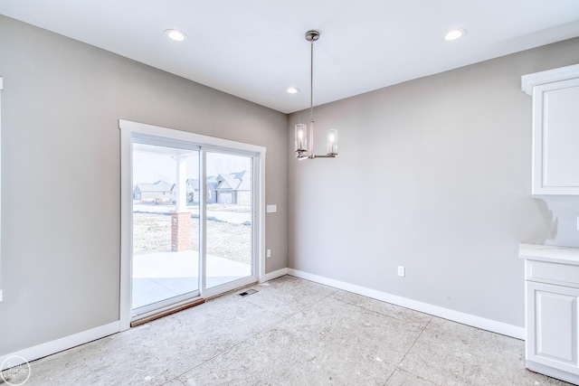 spare room featuring a notable chandelier