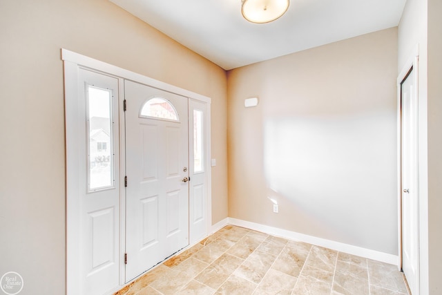 entryway featuring a healthy amount of sunlight and light tile flooring