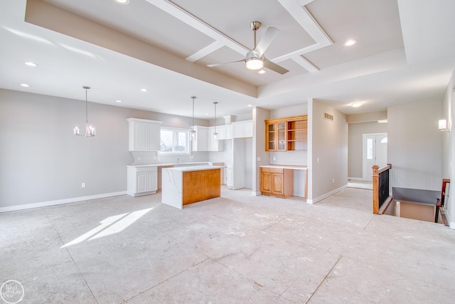 unfurnished living room featuring a raised ceiling and ceiling fan with notable chandelier